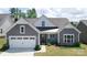 Charming home featuring a gray shingle exterior, white trim, well-manicured landscaping, and a welcoming front porch at 1360 Dali Blvd, Mount Holly, NC 28120