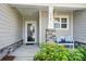 A welcoming front porch offers a cozy seating area with decorative pillows and attractive landscaping at 1360 Dali Blvd, Mount Holly, NC 28120