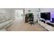 Spacious game room with a neon sign, entertainment setup, and neutral carpet at 1360 Dali Blvd, Mount Holly, NC 28120