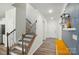 Bright hallway featuring elegant stairs with iron railings, modern lighting, and stylish decor accents at 1360 Dali Blvd, Mount Holly, NC 28120