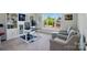 Bright home office featuring custom bookshelves, neutral walls, and a large window for ample natural light at 1360 Dali Blvd, Mount Holly, NC 28120