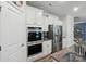 Modern kitchen design showcasing stainless steel appliances, granite countertops, and white cabinetry at 1360 Dali Blvd, Mount Holly, NC 28120