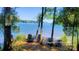 Stunning lake view with chairs overlooking the water at Sunflowers Point, perfect for relaxation and enjoying the scenery at 1360 Dali Blvd, Mount Holly, NC 28120