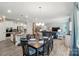 Open-concept living area adjacent to kitchen features lots of seating, dining area, and open floorplan at 1360 Dali Blvd, Mount Holly, NC 28120