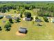 This aerial view highlights a home with large yard with a mix of trees and green grass at 1560 Springlake Rd, York, SC 29745