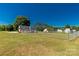 Large, fenced backyard with a detached building and mature trees surrounding the property at 1560 Springlake Rd, York, SC 29745