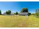 Expansive fenced backyard with lush green grass and mature trees at 1560 Springlake Rd, York, SC 29745