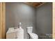 A bathroom with a white toilet, sink, and gray walls at 1560 Springlake Rd, York, SC 29745