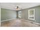 Bright bedroom with plush carpet, two windows, and neutral-colored walls at 1560 Springlake Rd, York, SC 29745