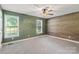 Bedroom featuring green walls, wood wall, ceiling fan, and natural light at 1560 Springlake Rd, York, SC 29745
