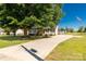 Expansive lot with a well-manicured lawn, mature tree, and driveway leading to the home and outbuildings at 1560 Springlake Rd, York, SC 29745