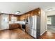 Kitchen featuring wood cabinets, stainless steel appliances, hardwood floors, and granite countertops at 1560 Springlake Rd, York, SC 29745