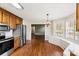 Open kitchen featuring a breakfast nook, stainless appliances, wood cabinets, and hardwood floors at 1560 Springlake Rd, York, SC 29745