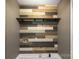 Laundry room features a colorful wood accent wall, a shelf, and updated fixtures at 1560 Springlake Rd, York, SC 29745