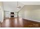 Bright living room featuring vaulted ceilings, a ceiling fan, fireplace, and hardwood floors at 1560 Springlake Rd, York, SC 29745