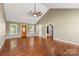 Open-concept living room featuring a vaulted ceiling, ceiling fan, hardwood floors, and natural light at 1560 Springlake Rd, York, SC 29745