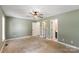 This main bedroom features neutral carpet, fan, and fresh green paint at 1560 Springlake Rd, York, SC 29745