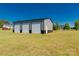 Large outbuilding with three garage doors, providing ample storage and workspace at 1560 Springlake Rd, York, SC 29745