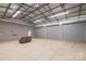 Spacious outbuilding with concrete floors, ample lighting, and large roll-up doors at 1560 Springlake Rd, York, SC 29745