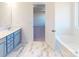 Stylish bathroom features modern vanity and sink, tiled floor, and soaking tub at 1817 Augustine St, Monroe, NC 28112