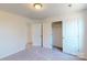 Carpeted bedroom featuring a walk-in closet with shelving and dual access doors at 1817 Augustine St, Monroe, NC 28112