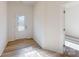 Bright entryway with wood-look flooring, a glass-paneled front door, and views into adjacent rooms at 1817 Augustine St, Monroe, NC 28112