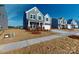 Beautiful gray two-story home with brick accents, a well-maintained lawn, and a two-car garage at 1817 Augustine St, Monroe, NC 28112