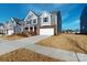 Attractive two-story home featuring gray siding, brick accents, and a spacious driveway on a sunny day at 1817 Augustine St, Monroe, NC 28112