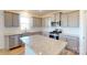 Modern kitchen with gray cabinets, granite countertops, stainless steel appliances, and an island at 1817 Augustine St, Monroe, NC 28112