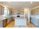 Beautiful kitchen featuring gray cabinets, a granite island, stainless steel appliances, and wood-look flooring at 1817 Augustine St, Monroe, NC 28112