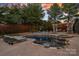 Expansive backyard showcasing a sparkling pool, cabana, and lounge area, ideal for relaxation and recreation at 18823 Peninsula Cove Ln, Cornelius, NC 28031