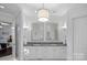 Elegant bathroom with double sinks, granite counters, white cabinetry, and decorative lighting at 18823 Peninsula Cove Ln, Cornelius, NC 28031