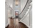 Elegant foyer with a stunning staircase, high ceilings, and a view of the front door, creating a grand entrance at 18823 Peninsula Cove Ln, Cornelius, NC 28031
