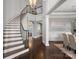 Grand foyer featuring a curved staircase, hardwood floors, and elegant chandelier at 18823 Peninsula Cove Ln, Cornelius, NC 28031