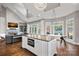Modern kitchen with large island, stainless appliances, and opens to a cozy living space at 18823 Peninsula Cove Ln, Cornelius, NC 28031