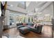 Spacious living room with a large sectional sofa, hardwood floors, and access to the backyard, blending comfort and style at 18823 Peninsula Cove Ln, Cornelius, NC 28031
