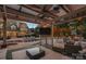 An outdoor living space featuring a covered patio, TV, outdoor kitchen, lounge chairs, and a swimming pool at 18823 Peninsula Cove Ln, Cornelius, NC 28031
