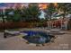 Stunning backyard with a refreshing pool, inviting lounge chairs, and a covered patio for relaxation at 18823 Peninsula Cove Ln, Cornelius, NC 28031
