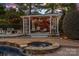 Outdoor poolhouse features a modern sitting area and lush landscaping at 18823 Peninsula Cove Ln, Cornelius, NC 28031