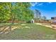 Backyard view with green grass, shade trees, a detached garage, wood fence and a concrete pad at 1924 Lakeview Dr, Rock Hill, SC 29732
