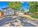 View of the backyard and back of the house with green grass, a wood fence and a concrete parking pad at 1924 Lakeview Dr, Rock Hill, SC 29732