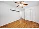 Bright bedroom with ceiling fan, hardwood floors, closet space and shelving creating a comfortable atmosphere at 1924 Lakeview Dr, Rock Hill, SC 29732