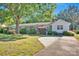 Exterior view featuring a brick home with blue shutters, a long driveway, and mature landscaping at 1924 Lakeview Dr, Rock Hill, SC 29732