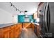 The updated kitchen is complete with wood cabinets, black appliances, and unique backsplash at 1924 Lakeview Dr, Rock Hill, SC 29732