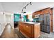 This kitchen boasts stainless steel appliances, wood cabinets, and a large island with cooktop at 1924 Lakeview Dr, Rock Hill, SC 29732