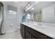 Bright bathroom with double vanity, white countertop, dark wood cabinets, and a separate shower area at 2015 Knocktree Dr, Indian Trail, NC 28079