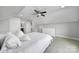 Bright bedroom featuring carpeted floors, ceiling fan, and crisp white bedding at 2015 Knocktree Dr, Indian Trail, NC 28079