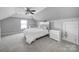 Cozy bedroom featuring carpeted floors, ceiling fan, and crisp white bedding at 2015 Knocktree Dr, Indian Trail, NC 28079