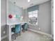 Bright bedroom featuring a built-in desk area, pendant lights, and window at 2015 Knocktree Dr, Indian Trail, NC 28079