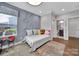 Comfortable bedroom with an area rug, geometric-patterned wall, and natural light at 2015 Knocktree Dr, Indian Trail, NC 28079